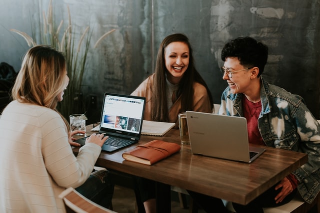 three people working at a desk