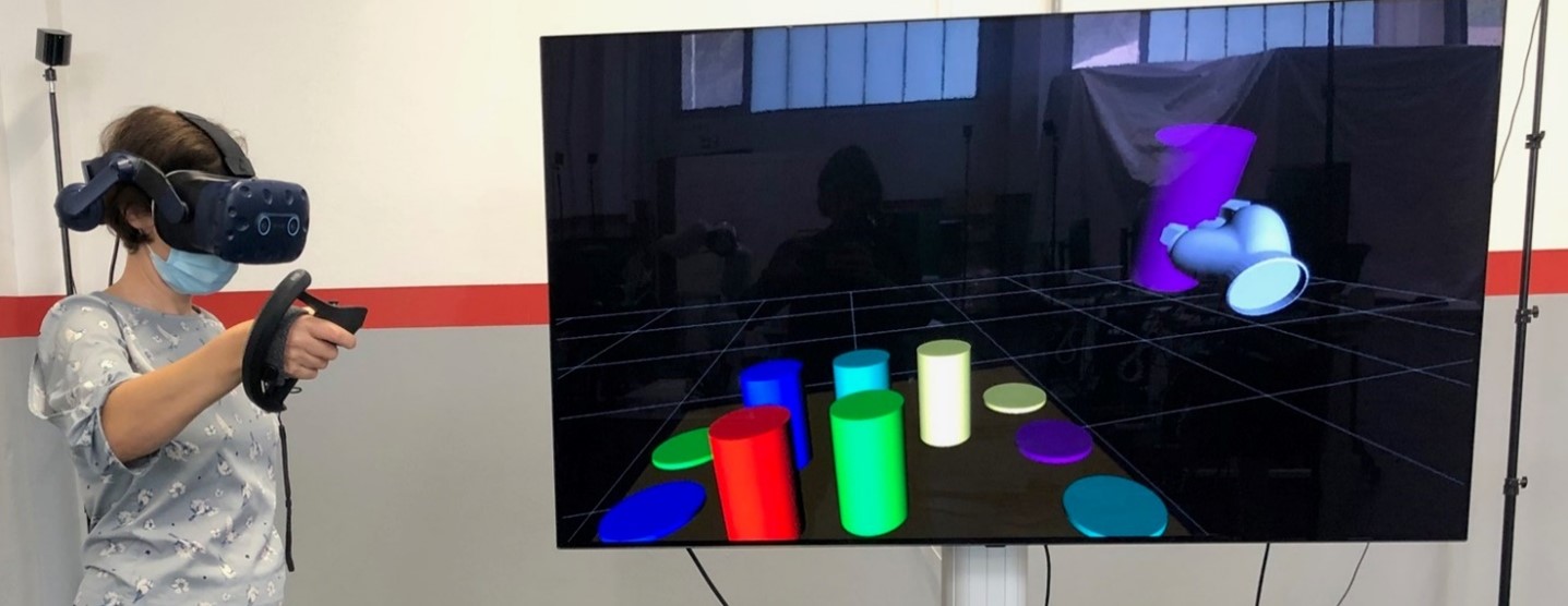 child with VR headset and image of blocks on a table