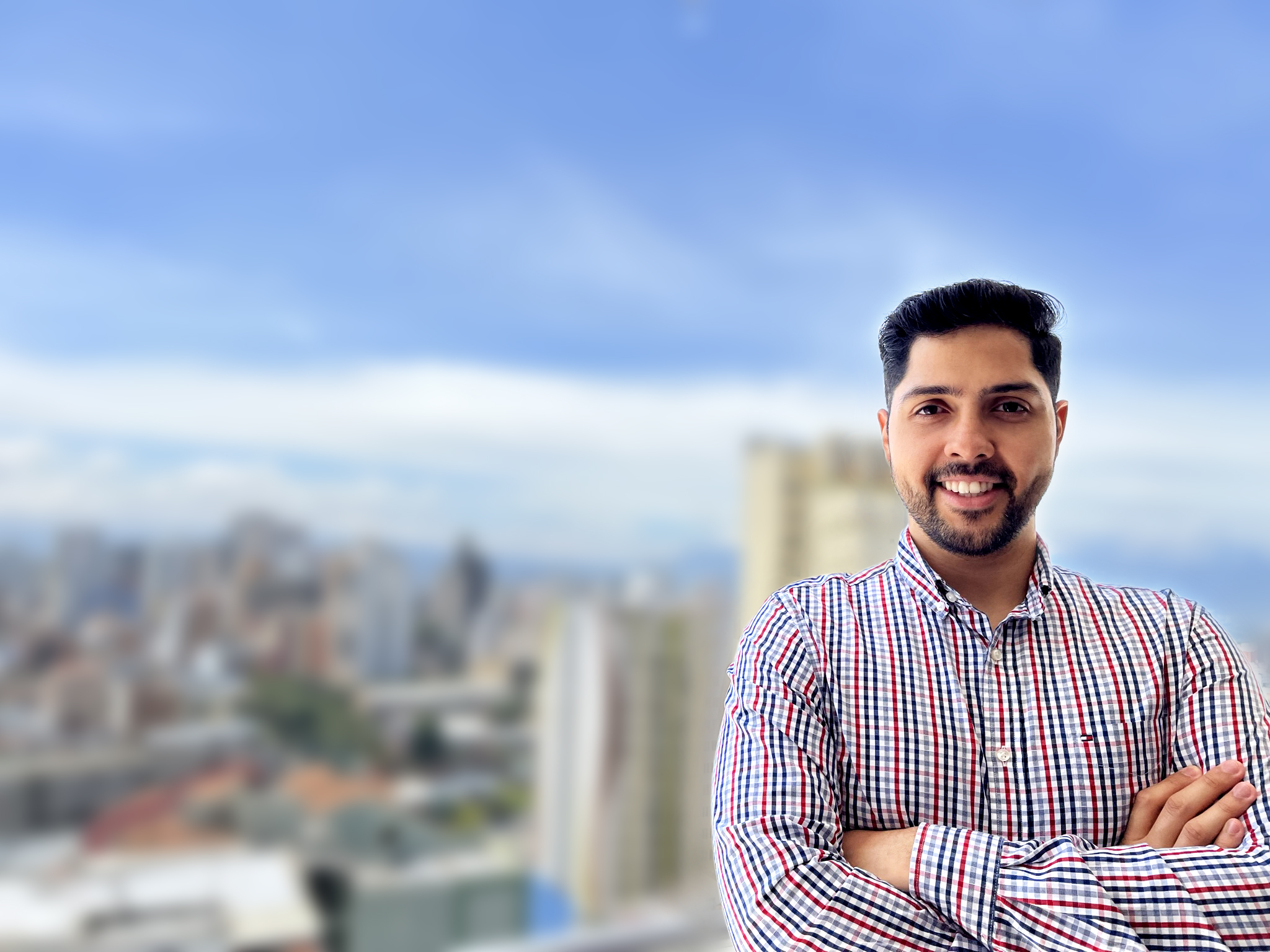 Carlos in front of a cityscape