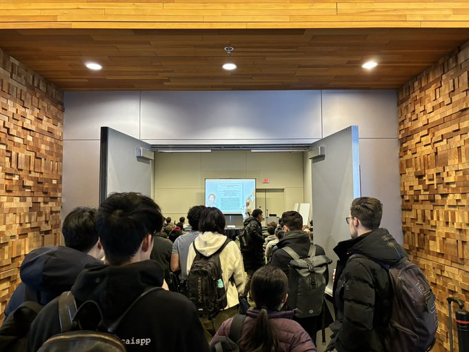 A crowd of people outside a packed room